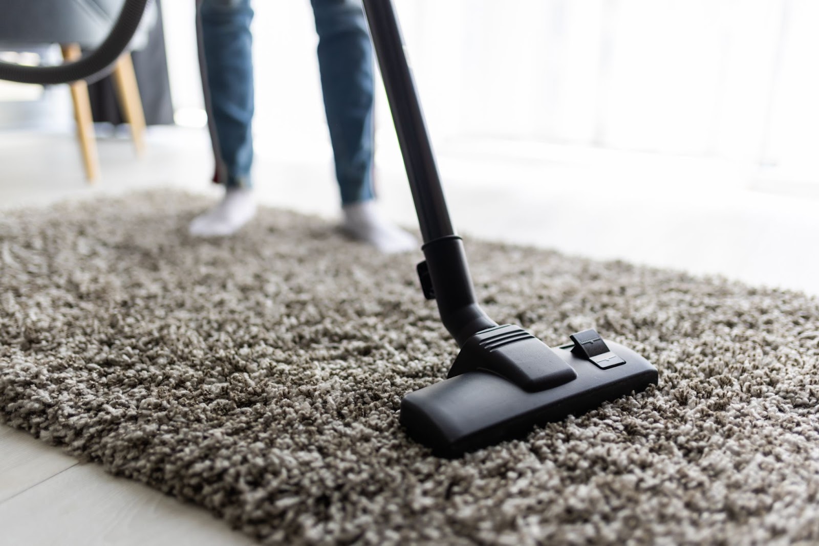 People-housework-housekeeping-concept-close-up-woman-with-legs-vacuum-cleaner-cleaning-carpet-home