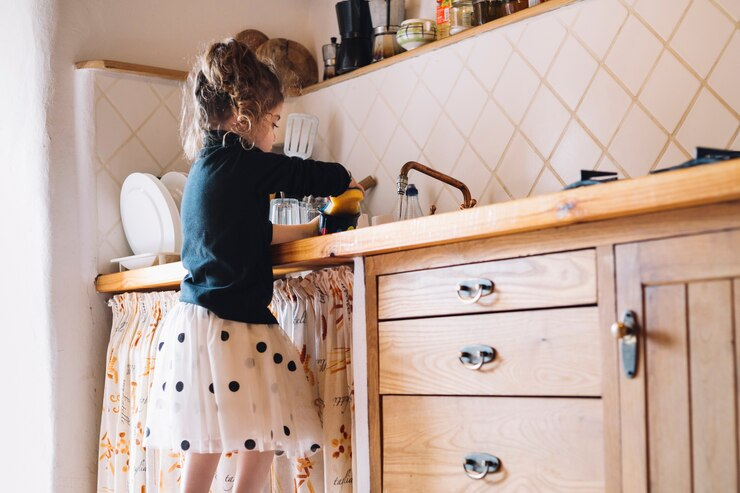 girl cleaning dishes in the kitchen