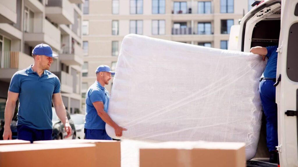 movers loading a mattress into van