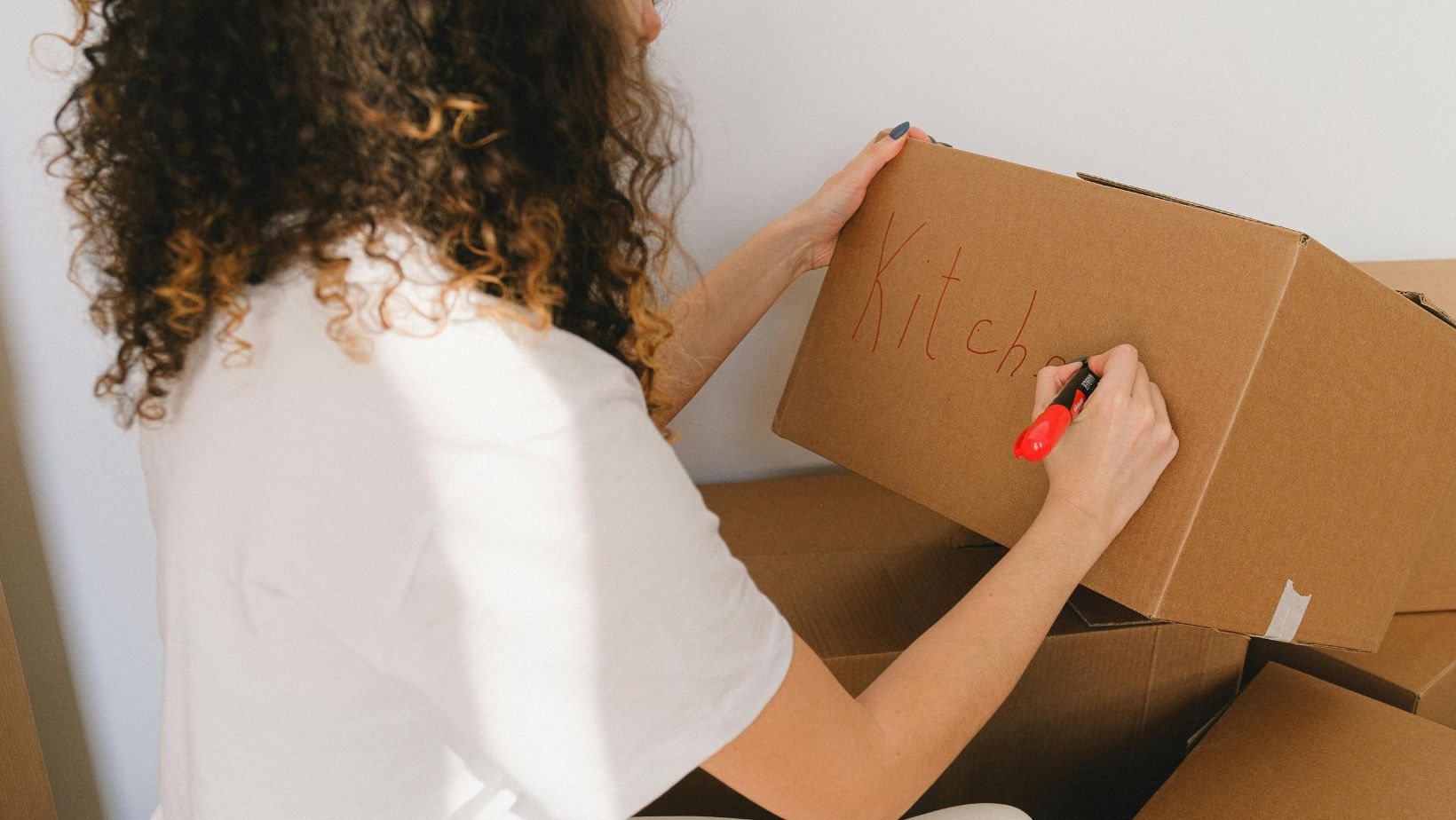 Person writing on a box