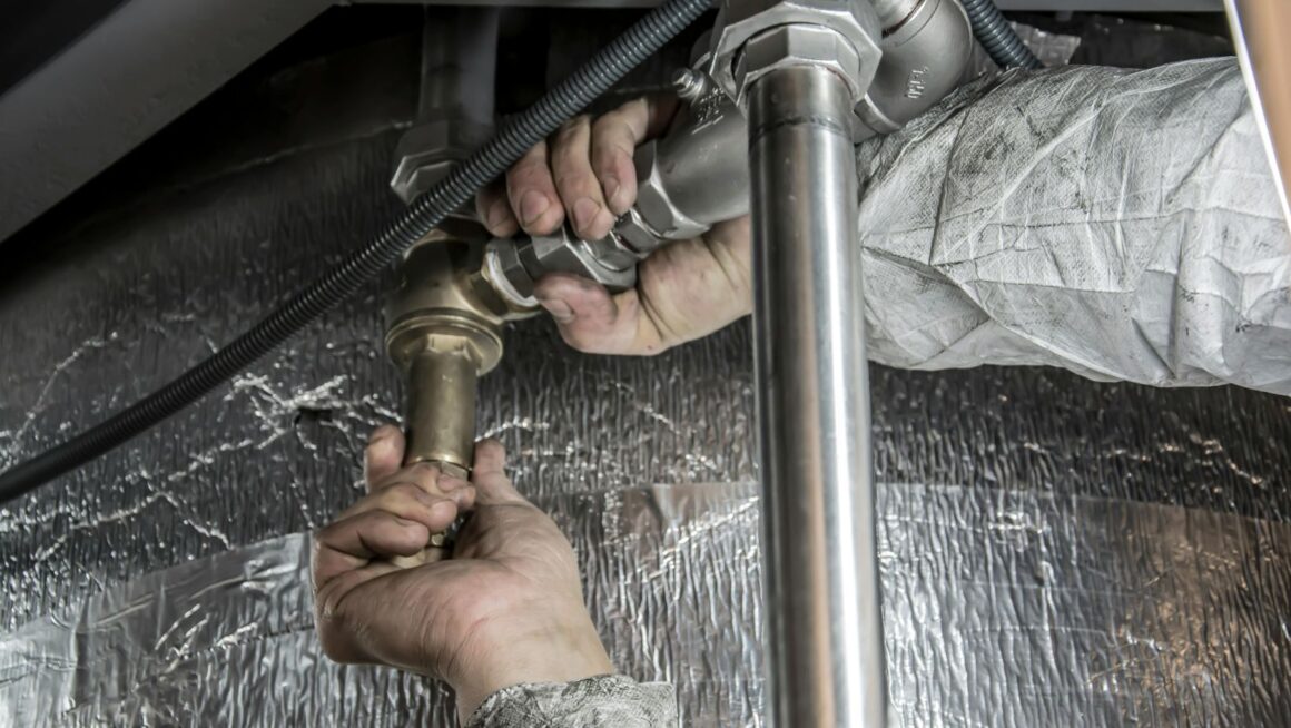 Plumber fixing pipes