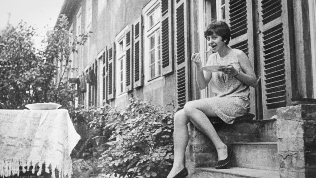 An old photo of a person sitting on the stairs.