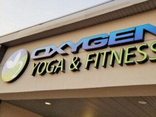 illuminated Oxygen Yoga and Fitness storefront sign