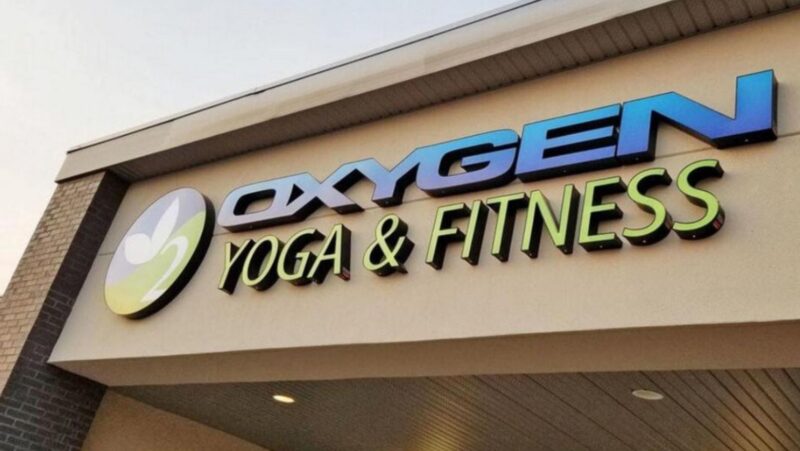 illuminated Oxygen Yoga and Fitness storefront sign