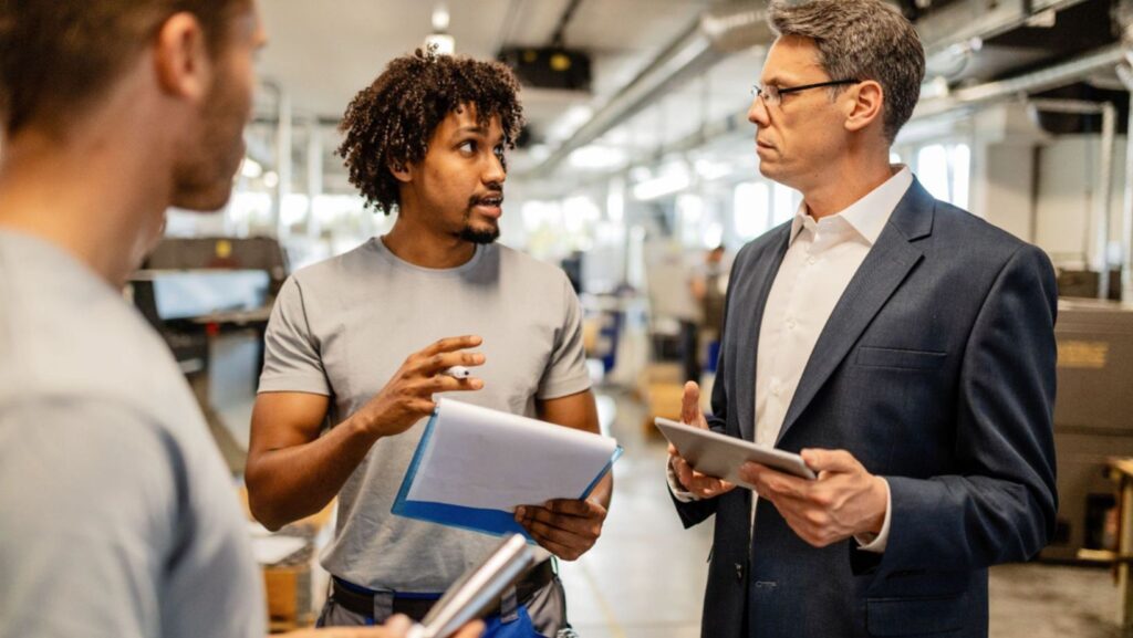 Factory team discussing production workflow