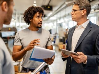 Factory team discussing production workflow