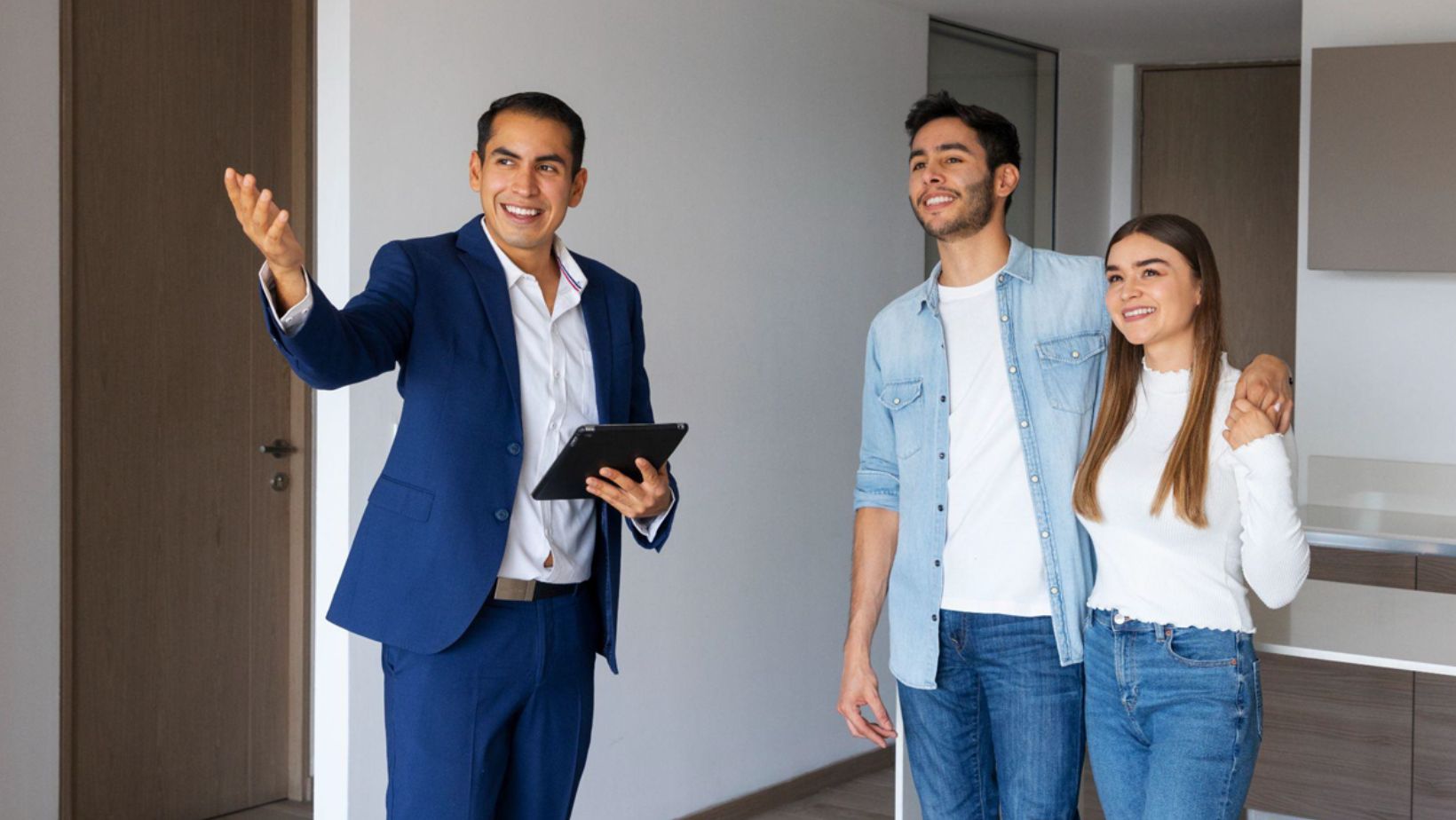 Couple touring apartment with real estate agent